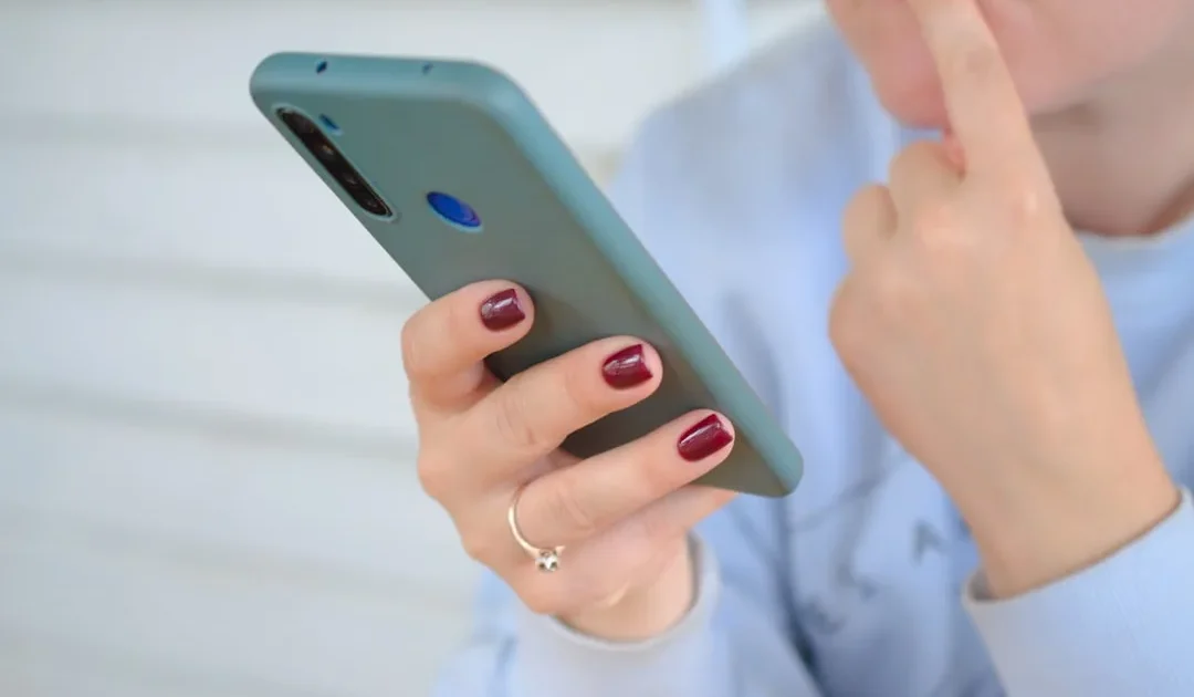 Person looking at phone showing text conversation about how to respond when someone ghosts you then comes back