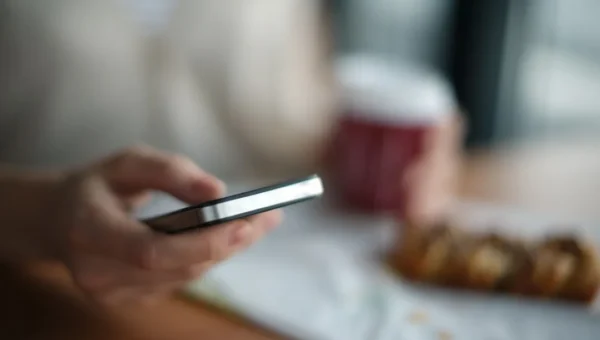 Person typing text message response on smartphone showing best replies when someone says K