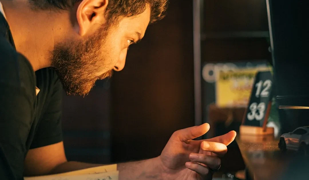 Person thoughtfully looking at their phone while considering how to reply to a text message request